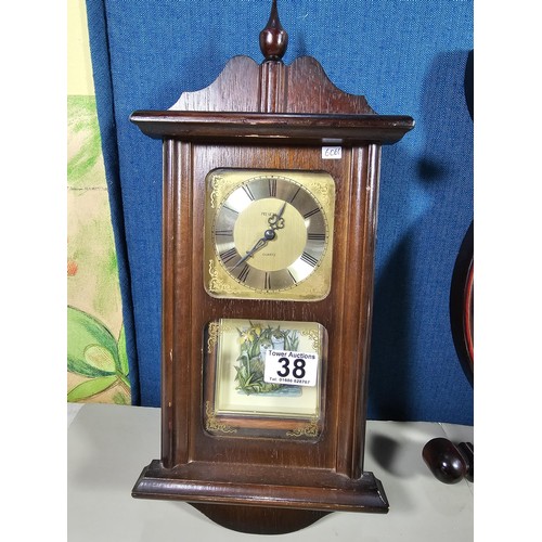 38 - A collection of 3 quartz battery operated clocks to include a wall hanging owl formed clock, a wall ... 
