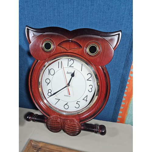 38 - A collection of 3 quartz battery operated clocks to include a wall hanging owl formed clock, a wall ... 