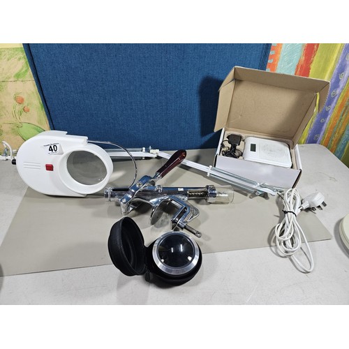 A large angle poise magnifier with built in light missing its clamp for ...