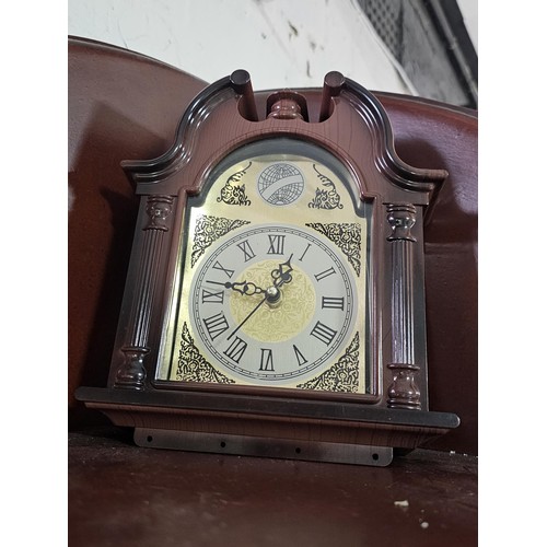 41 - A large selection of battery operated clocks of various styles to include an anniversary clock in a ... 