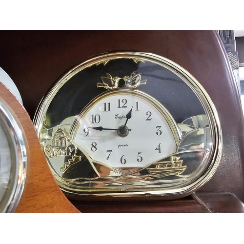 41 - A large selection of battery operated clocks of various styles to include an anniversary clock in a ... 