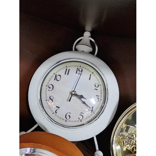 41 - A large selection of battery operated clocks of various styles to include an anniversary clock in a ... 