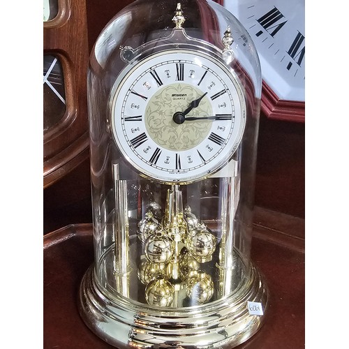 41 - A large selection of battery operated clocks of various styles to include an anniversary clock in a ... 