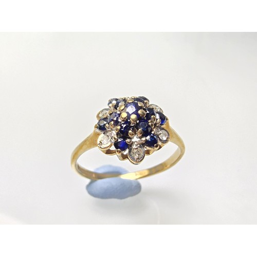 394 - A very pretty hallmarked 9ct yellow gold diamond and sapphire cluster ring set with 6 round cut diam... 