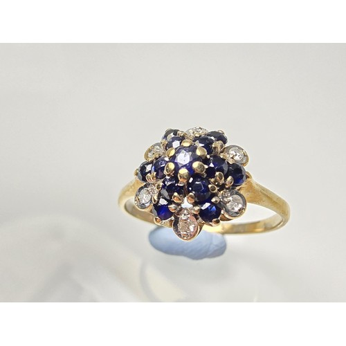 394 - A very pretty hallmarked 9ct yellow gold diamond and sapphire cluster ring set with 6 round cut diam... 