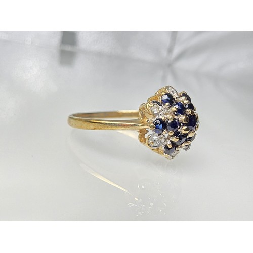 394 - A very pretty hallmarked 9ct yellow gold diamond and sapphire cluster ring set with 6 round cut diam... 