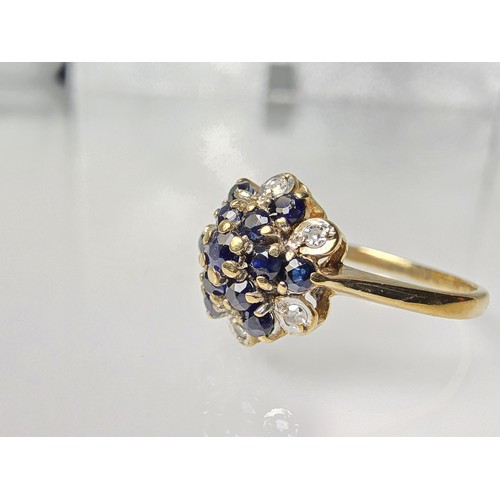 394 - A very pretty hallmarked 9ct yellow gold diamond and sapphire cluster ring set with 6 round cut diam... 