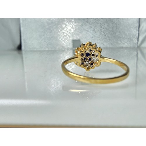 394 - A very pretty hallmarked 9ct yellow gold diamond and sapphire cluster ring set with 6 round cut diam... 