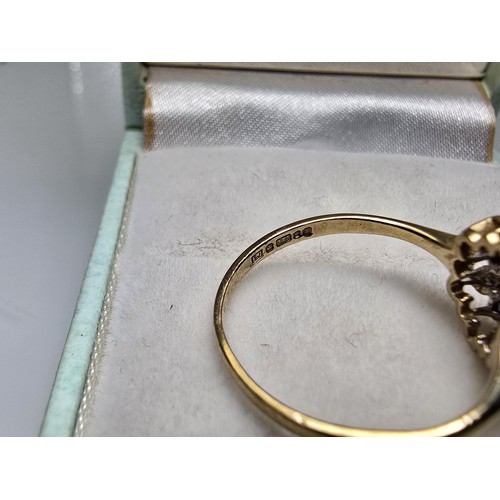 394 - A very pretty hallmarked 9ct yellow gold diamond and sapphire cluster ring set with 6 round cut diam... 