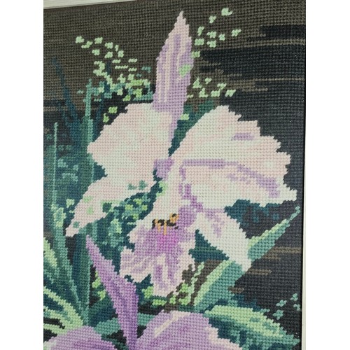 61 - 4x framed and glazed needlework pictures to include a white framed image of purple flowers, a gilt f... 