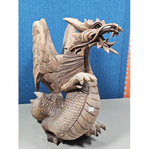 69 - A hand carved solid wood dragon figure, very well detailed. It has minor damage to 1 caw otherwise i... 