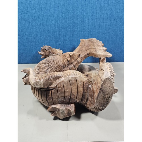 69 - A hand carved solid wood dragon figure, very well detailed. It has minor damage to 1 caw otherwise i... 