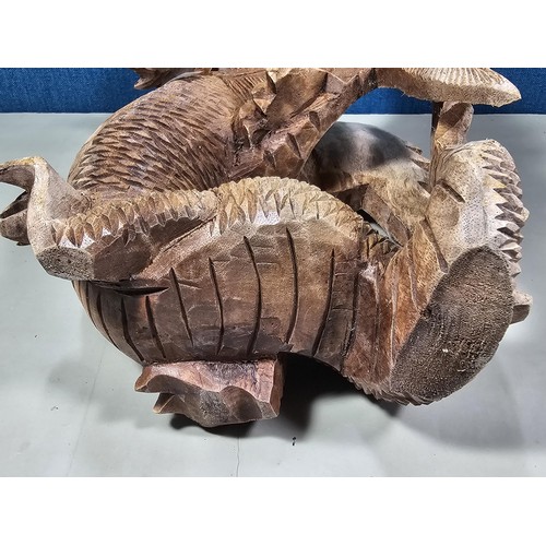 69 - A hand carved solid wood dragon figure, very well detailed. It has minor damage to 1 caw otherwise i... 