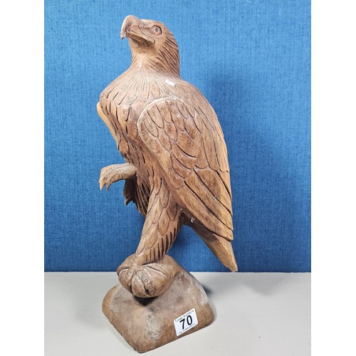 70 - A good quality hand carved solid wood eagle figure standing on a plinth, in very good detail. Has a ... 