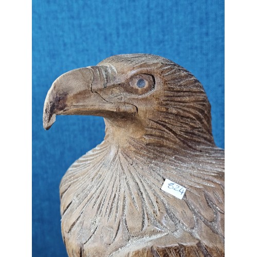 70 - A good quality hand carved solid wood eagle figure standing on a plinth, in very good detail. Has a ... 
