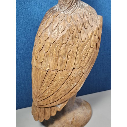 70 - A good quality hand carved solid wood eagle figure standing on a plinth, in very good detail. Has a ... 
