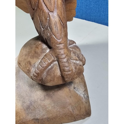 70 - A good quality hand carved solid wood eagle figure standing on a plinth, in very good detail. Has a ... 