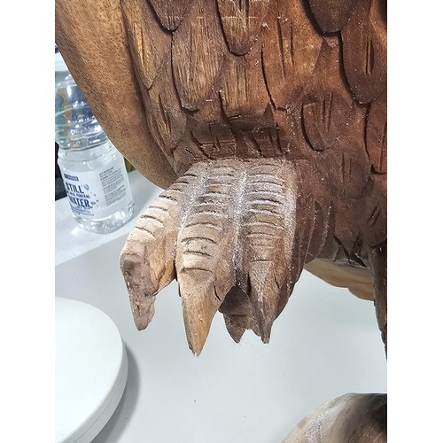 70 - A good quality hand carved solid wood eagle figure standing on a plinth, in very good detail. Has a ... 