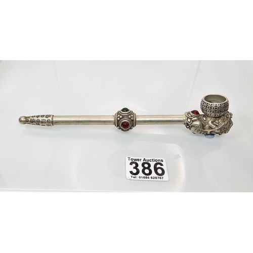 386 - An impressive ornate white metal long Asian Smoking Pipe having a jewelled design to the centre of t... 