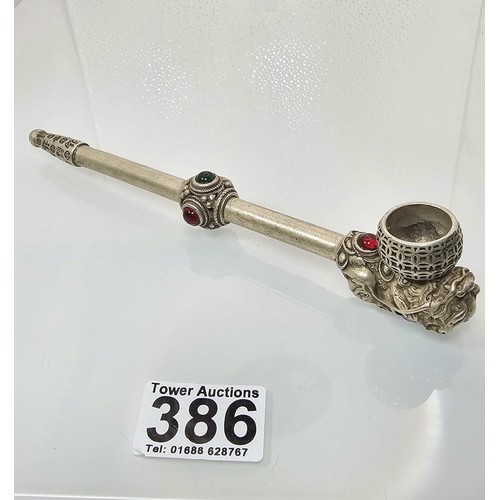 386 - An impressive ornate white metal long Asian Smoking Pipe having a jewelled design to the centre of t... 