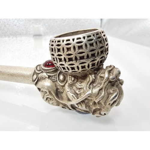 386 - An impressive ornate white metal long Asian Smoking Pipe having a jewelled design to the centre of t... 