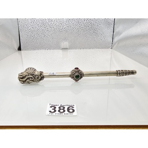 386 - An impressive ornate white metal long Asian Smoking Pipe having a jewelled design to the centre of t... 