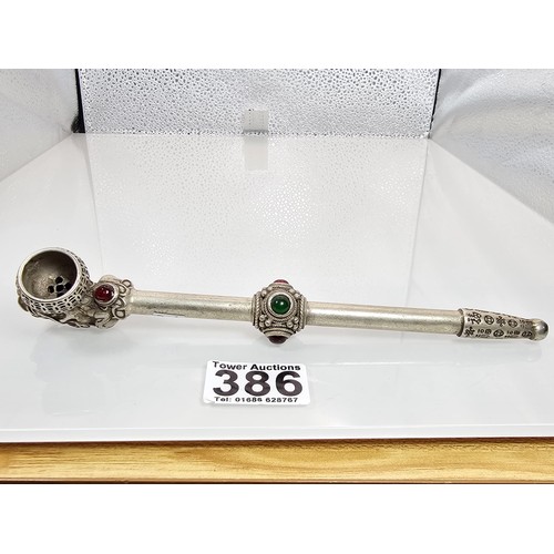 386 - An impressive ornate white metal long Asian Smoking Pipe having a jewelled design to the centre of t... 