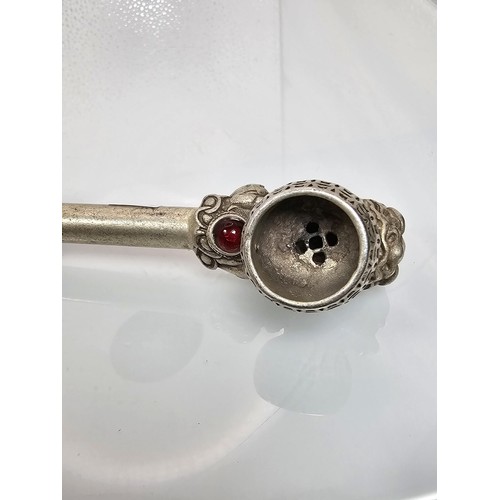 386 - An impressive ornate white metal long Asian Smoking Pipe having a jewelled design to the centre of t... 
