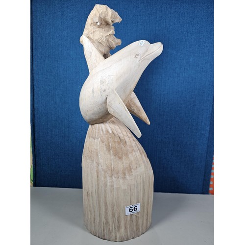 66 - A large hand carved wooden sculpture of a leaping dolphin, well executed, with no visible damage. It... 