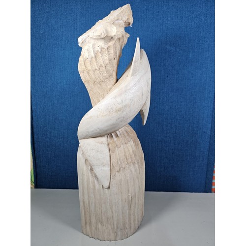 66 - A large hand carved wooden sculpture of a leaping dolphin, well executed, with no visible damage. It... 