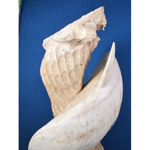 66 - A large hand carved wooden sculpture of a leaping dolphin, well executed, with no visible damage. It... 
