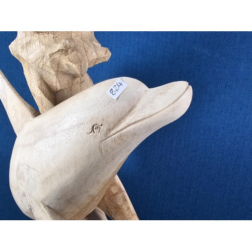 66 - A large hand carved wooden sculpture of a leaping dolphin, well executed, with no visible damage. It... 