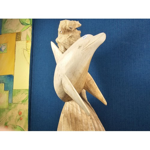 66 - A large hand carved wooden sculpture of a leaping dolphin, well executed, with no visible damage. It... 