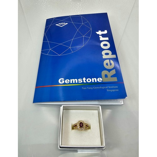 406 - A fine quality 18ct Gold Ruby & Diamond Halo Ring. Claw set with an oval cut natural Ruby weighing 0... 