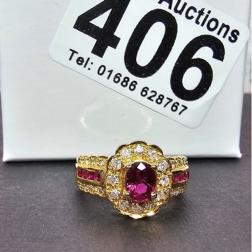 406 - A fine quality 18ct Gold Ruby & Diamond Halo Ring. Claw set with an oval cut natural Ruby weighing 0... 