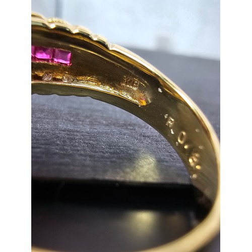 406 - A fine quality 18ct Gold Ruby & Diamond Halo Ring. Claw set with an oval cut natural Ruby weighing 0... 