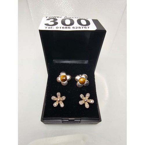 300 - 2x pairs of as new 925 Silver stud earrings. Both are flower formed. One pair is set with Tigers Eye... 