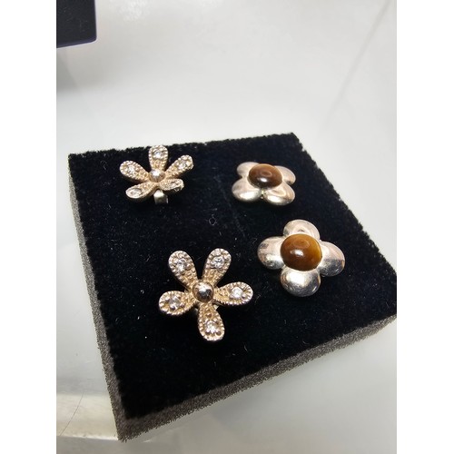 300 - 2x pairs of as new 925 Silver stud earrings. Both are flower formed. One pair is set with Tigers Eye... 