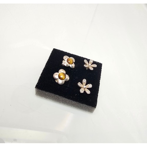 300 - 2x pairs of as new 925 Silver stud earrings. Both are flower formed. One pair is set with Tigers Eye... 