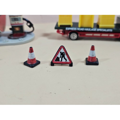 167 - A small collection of Eddie Stobart diecast vehicles to include a curtain side lorry with spare curt... 