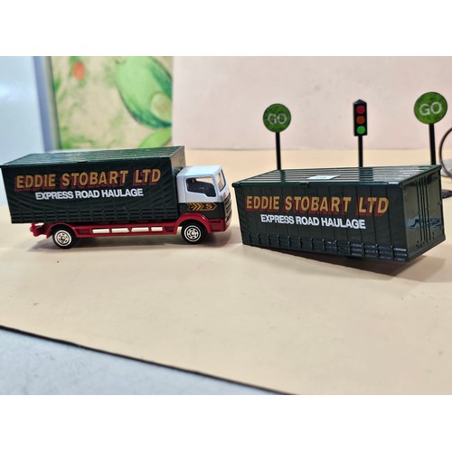 167 - A small collection of Eddie Stobart diecast vehicles to include a curtain side lorry with spare curt... 