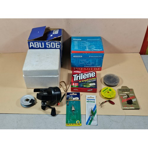 178 - A boxed Abu 50g auto sync reel along with a quanitity of fishing accessories to include fishing line... 