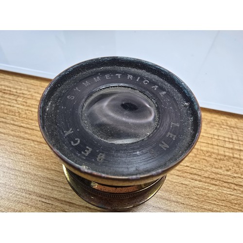 274 - A late 19th century antique Beck symmetrical brass camera lens complete with its original leather ca... 