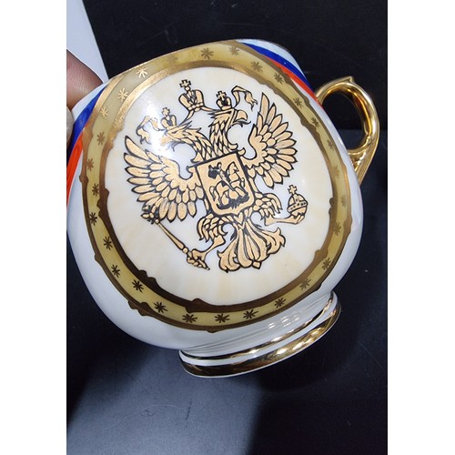 276 - A rare collectable Russian porcelain egg teacup and lid, it is decorated with a Russian flag motif a... 