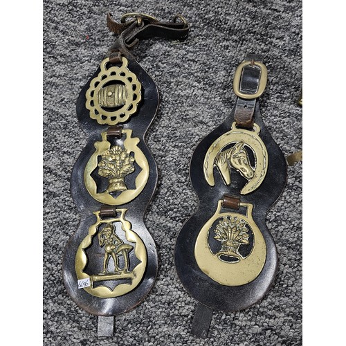 221 - A small crate containing a quantity of assorted brassware to include horse brasses, owl formed trive... 