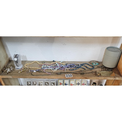 232 - A small quantity of costume jewellery to include beaded necklaces, a metal bracelet with enamel pict... 