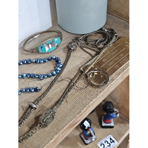 232 - A small quantity of costume jewellery to include beaded necklaces, a metal bracelet with enamel pict... 