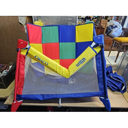 487 - Pack & play compact childs playpen in bright primary colours, complete with carry case. Playpen open... 
