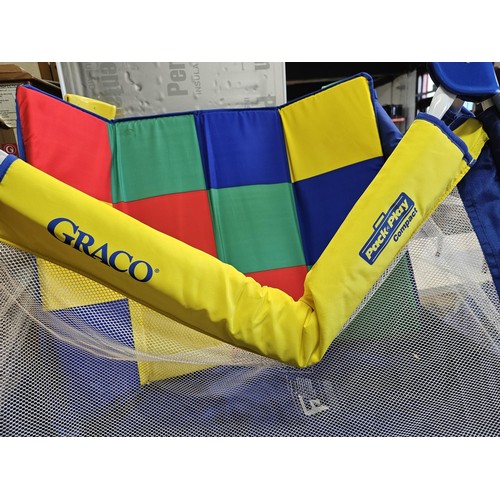 487 - Pack & play compact childs playpen in bright primary colours, complete with carry case. Playpen open... 