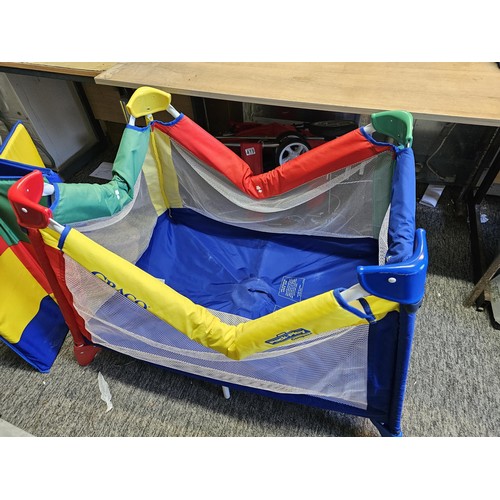 487 - Pack & play compact childs playpen in bright primary colours, complete with carry case. Playpen open... 